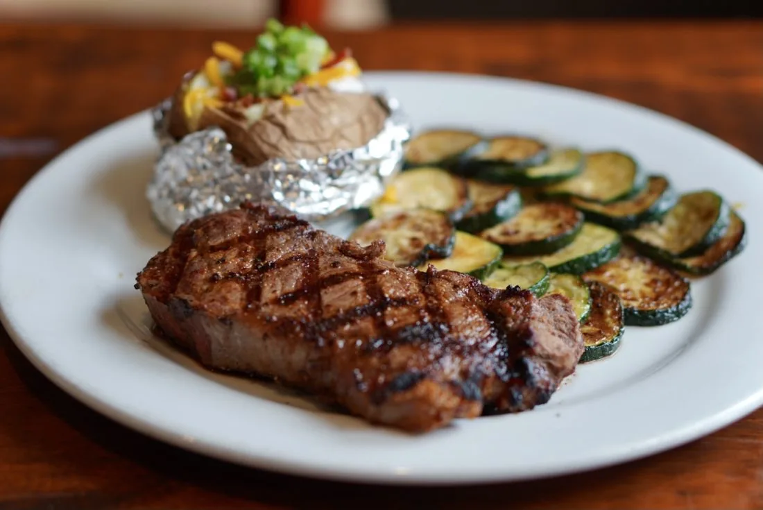 Grilled steak with loaded baked potato